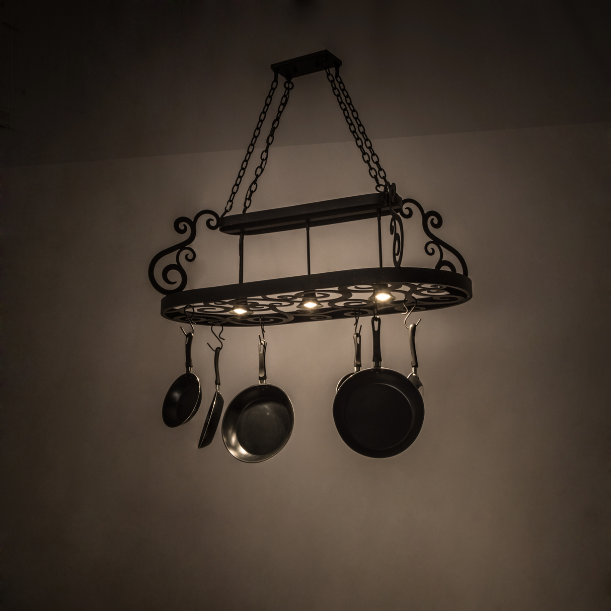 Neo 3-Light Pot Rack illuminated with warm kitchen ambiance.