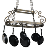 Bronze scrollwork oval pot rack with pans, angled view.