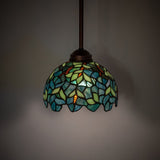 Illuminated view of the Nightfall Wisteria mini pendant, showcasing rich colors and intricate design.