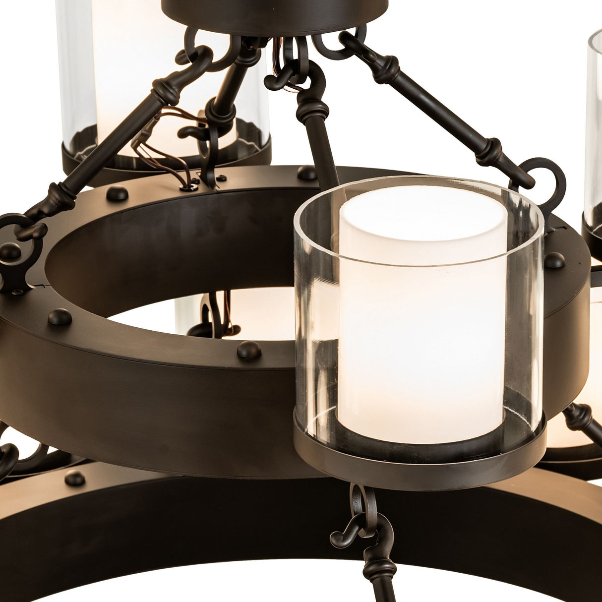 Close-up view of cylindrical glass diffuser mounted on metal ring bobeche.