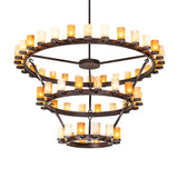 Lit view of three-tier ring chandelier featuring amber-toned cylindrical glass shades.