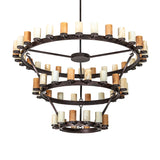 Unlit view of three-tier ring chandelier with cylindrical glass shades and bronze rings.