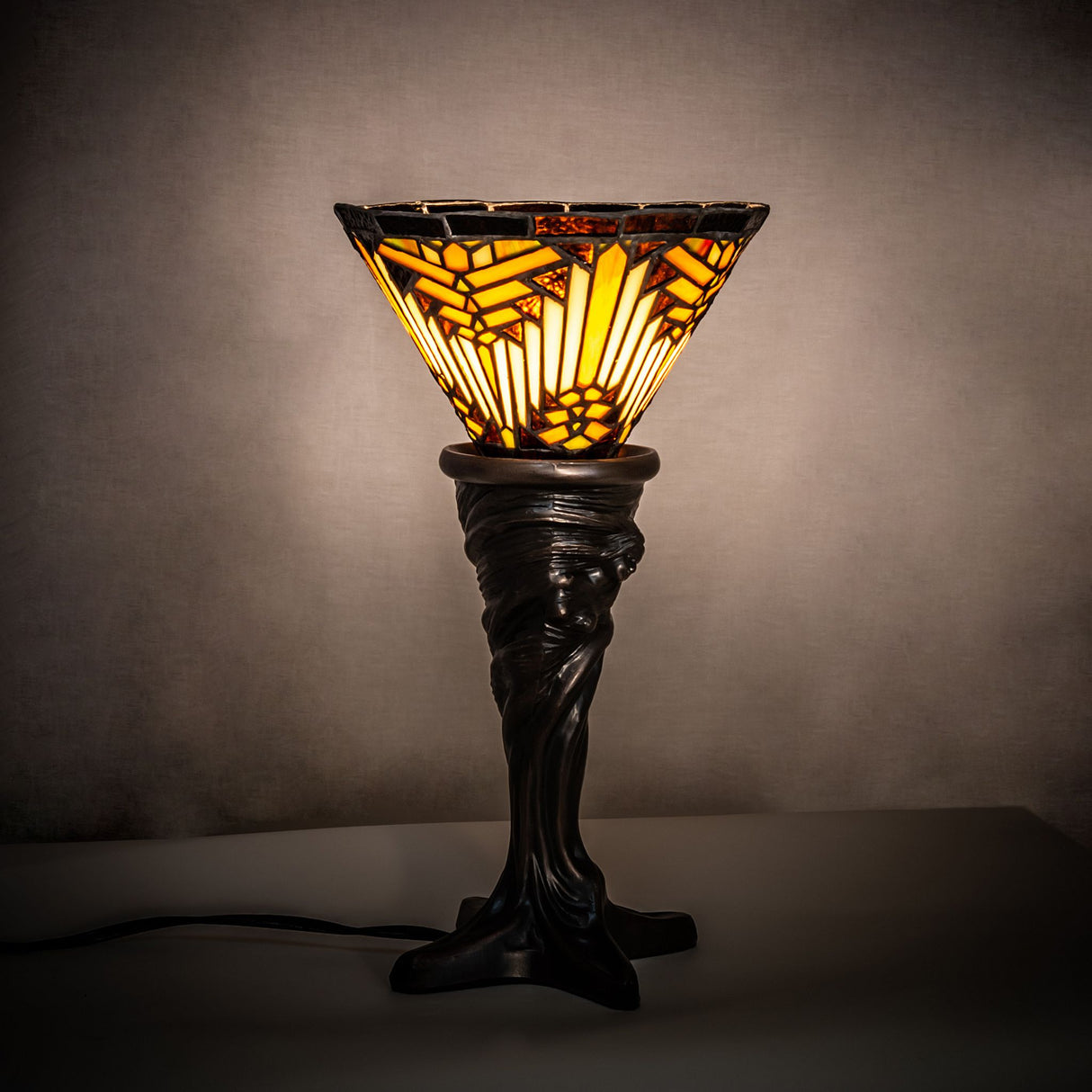 Illuminated view showcasing the warm glow of the Nuevo Mission Mini Lamp.