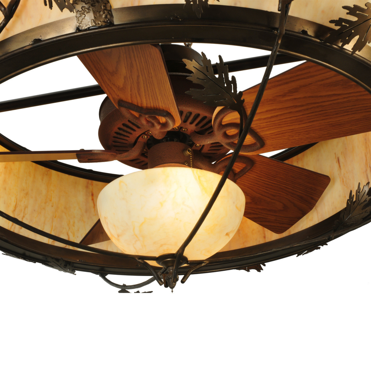 Close-up of fan blades and dome light behind oak leaf pattern.