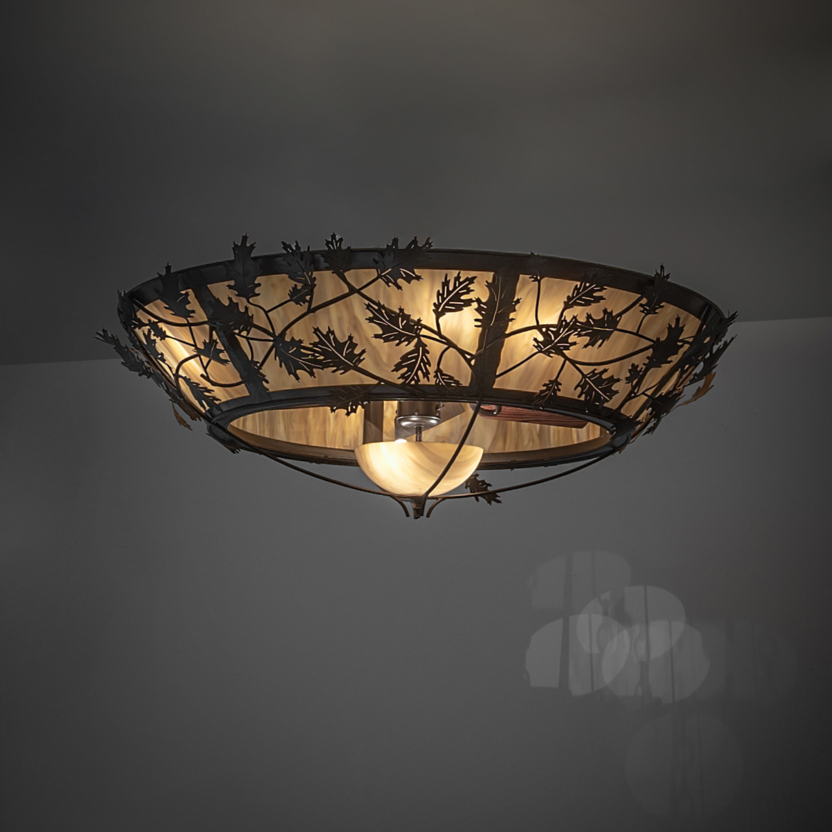 Oak Branch chandelier fan glowing with warm Travertine Idalight diffuser.