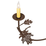 Detailed view of candle holder and leaf accents on chandelier arm.