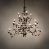 Oak leaf 15 light chandelier illuminated in an ambient room setting.