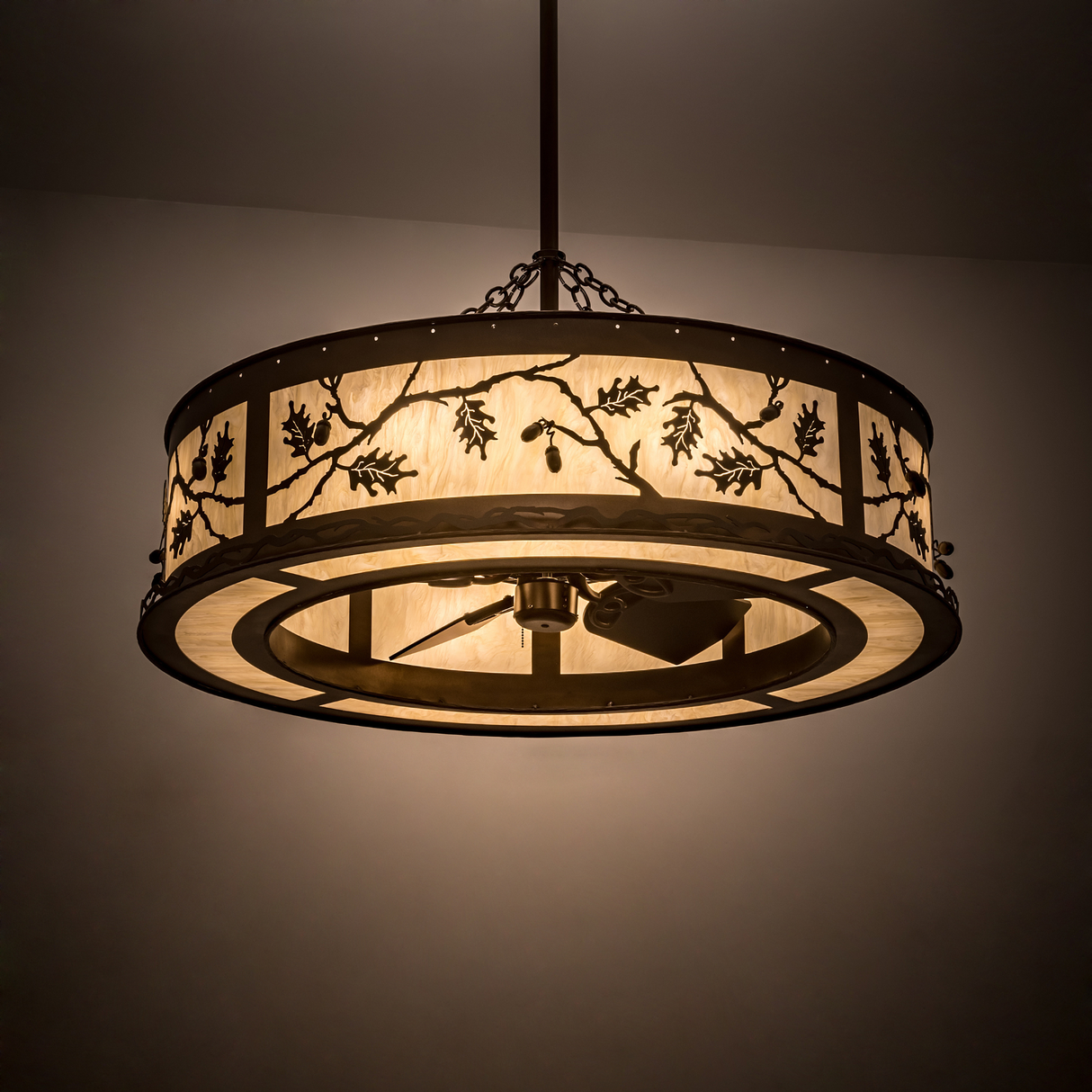 Oak Leaf & Acorn Chandel-Air glowing warmly in a dimly lit room.