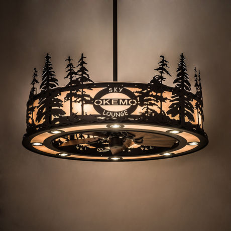 Illuminated Okemo Sky Lounge Chandel-Air glowing warmly in a dark room with pine silhouette design.