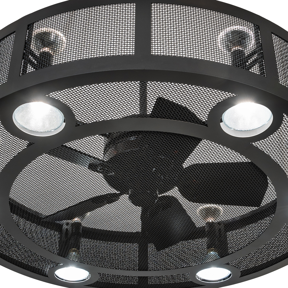 Close-up of fan blades and light housing inside mesh frame.