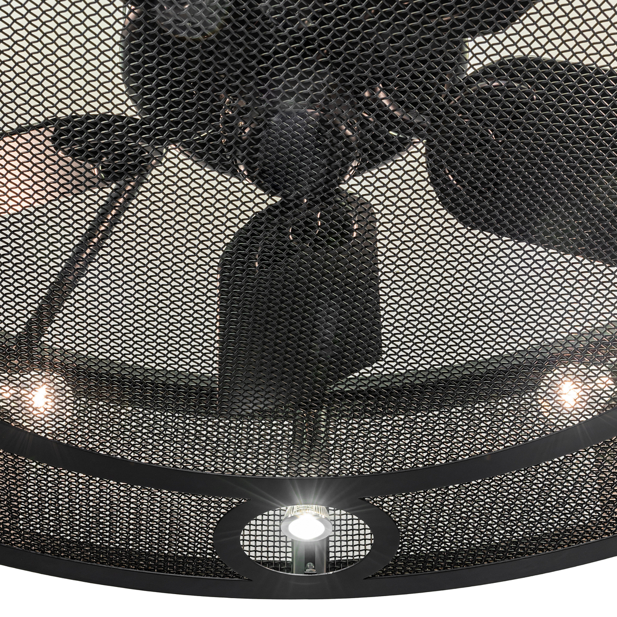 Close-up of mesh grille and fan blades on Paloma Golpe chandelier.