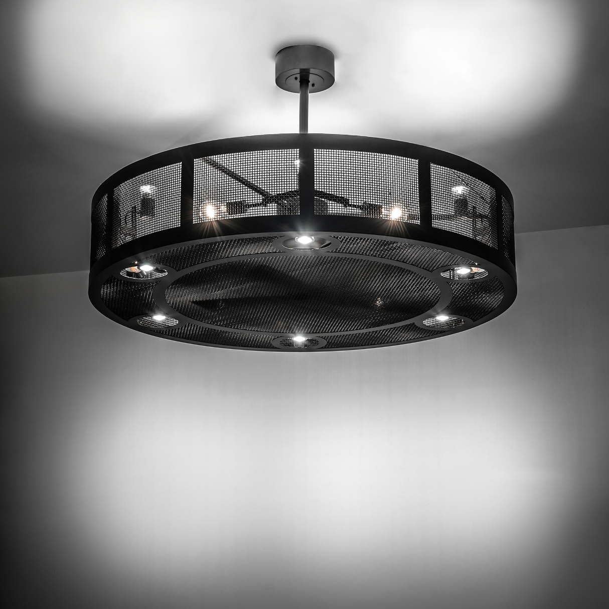 Illuminated Paloma Golpe chandelier fan glowing in ambient light.