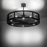 Illuminated Paloma Golpe chandelier fan glowing in ambient light.