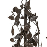 Closeup of leaf and branch scrollwork around candlelight holder.