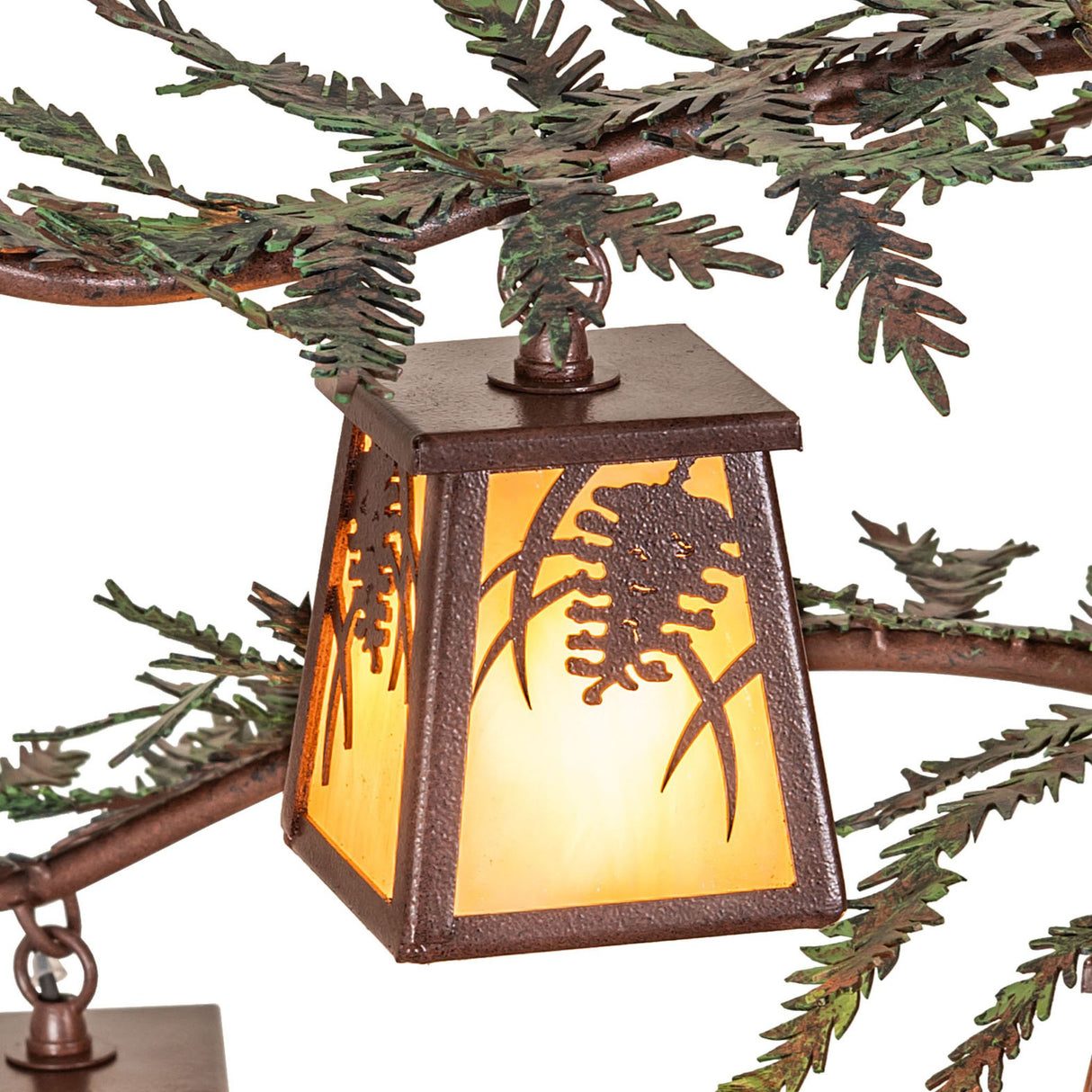 Top view of lit lantern shade attached to pine branch arm chandelier.