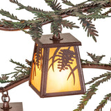 Top view of lit lantern shade attached to pine branch arm chandelier.
