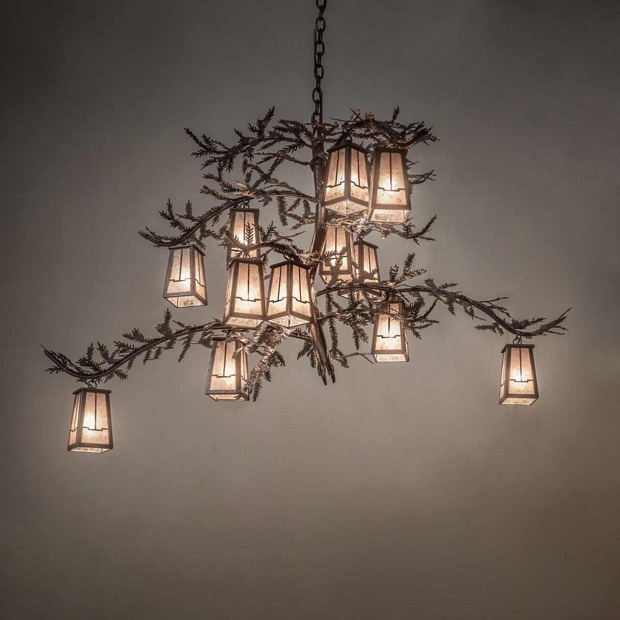 Ambient lighting view of chandelier with warm glowing silver mica lanterns.