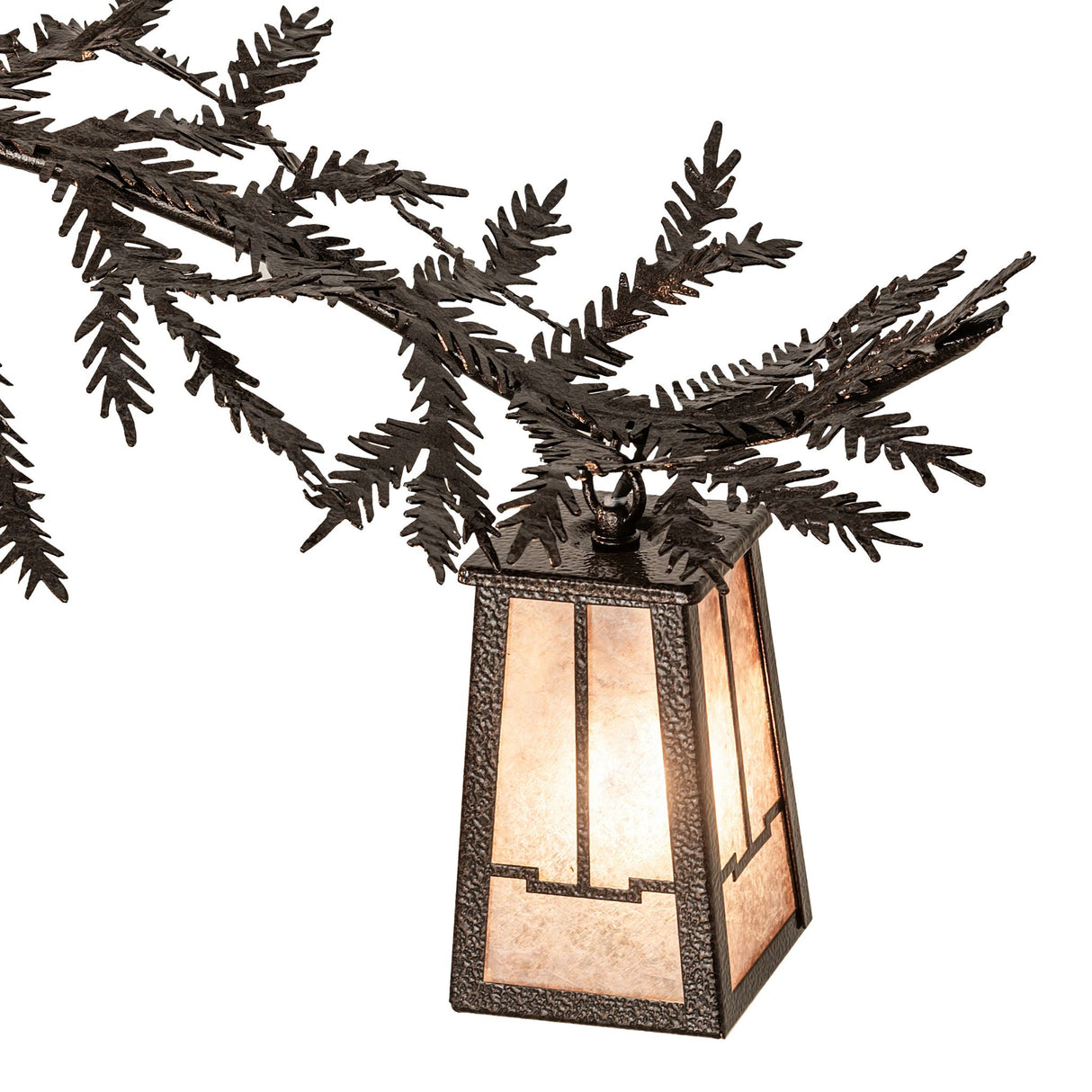 Close-up of silver mica lantern with pine branch and needle metal detailing.