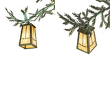 Detail view of metal pine needles and lantern shade craftsmanship.