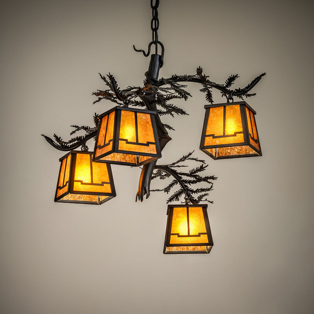 Illuminated in ambient room setting with warm amber mica glow and rustic pine branch detailing.