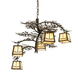Lit view chandelier with five art glass lanterns and pine needle metal accents.