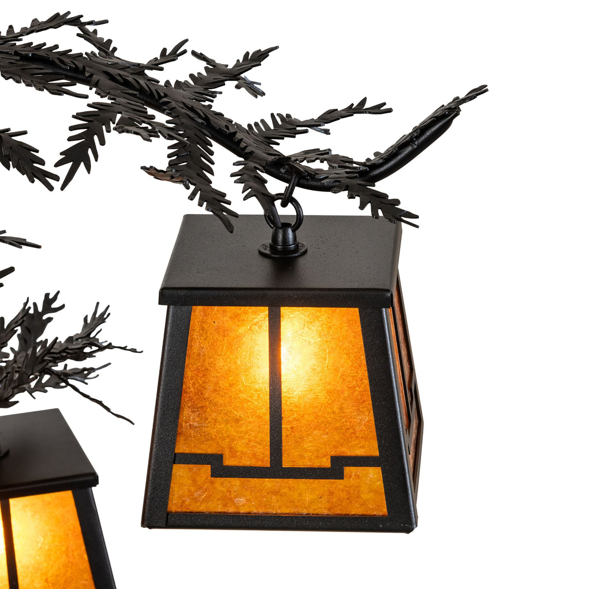 Detailed view metal arms with layered pine needle accents in textured black finish.