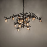 Pine Branch chandelier lit with warm ambient glow highlighting pine branch arms.