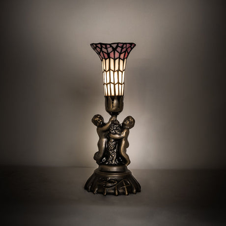 Cherub lamp illuminated in a soft ambient setting.