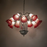 Ambient lighting view of chandelier showing warm glow and glass color variation.
