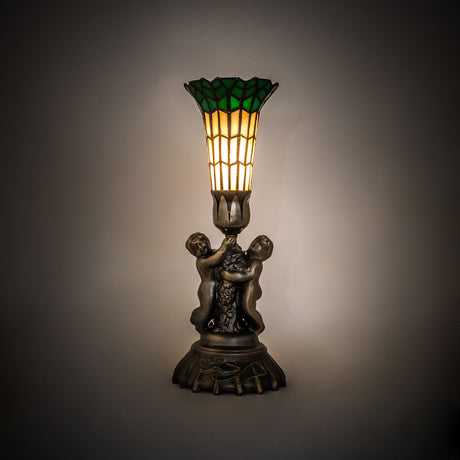Pond Lily Twin Cherub Accent Lamp illuminated in a setting with warm light and intricate details.