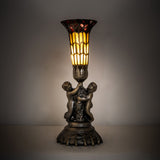Lit view of the Pond Lily Twin Cherub accent lamp with amber and red glass shade.