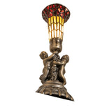 Angled view of the Pond Lily Twin Cherub lamp featuring antique brass cherub figures.