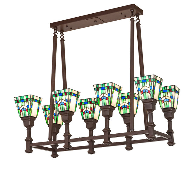 Lit view of 8-light oblong chandelier with stained glass shades and cafe noir finish.