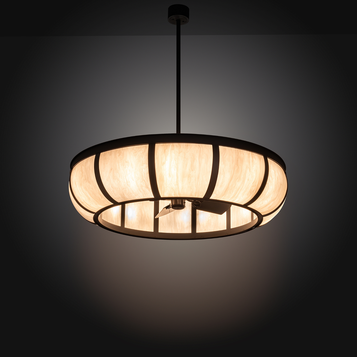 Illuminated Prime Dome Chandel-Air glowing warmly in dark room setting.
