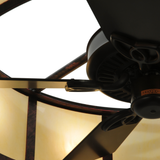 Overhead close-up of fan blades within illuminated dome diffuser.