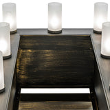 Close-up of the top platform with frosted glass uplight cylinders illuminated.