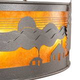 Close-up of cabin and mountain cutout with warm amber mica glow.
