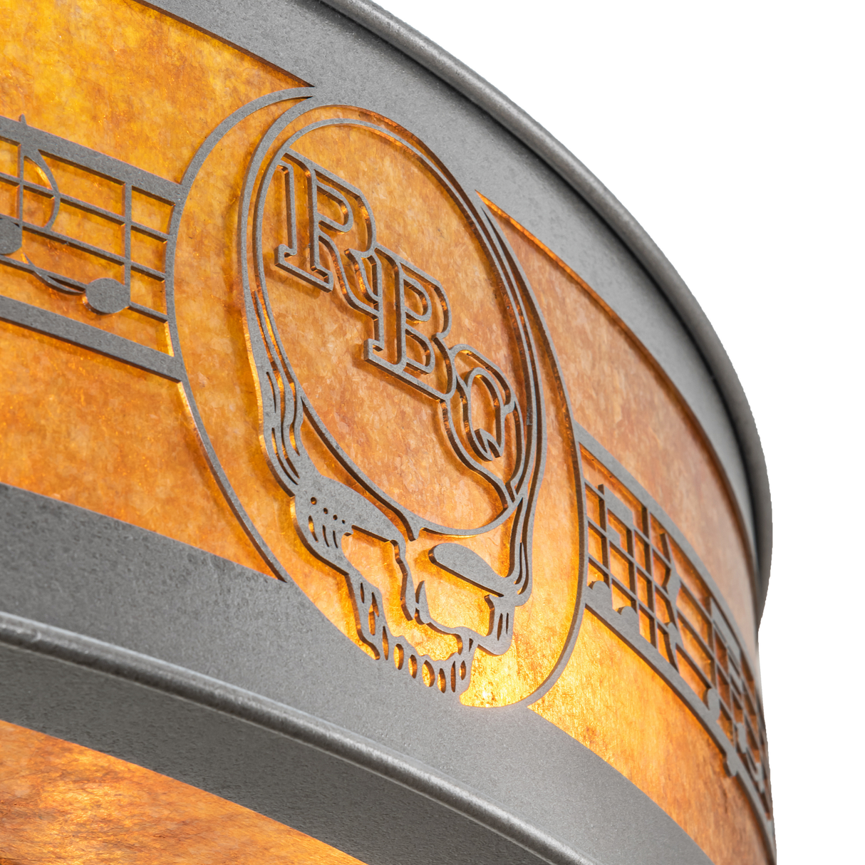 Close-up of RBQ logo with musical note pattern and glowing mica diffuser.