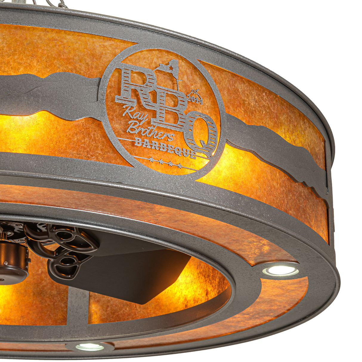 Close-up of RBQ logo on amber mica with metallic landscape design.