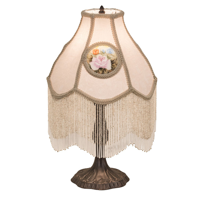 Full view of a 20" high reverse-painted roses table lamp with ivory fabric and fringe.