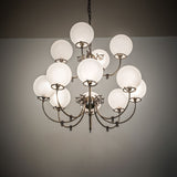 Revival 12-light chandelier glowing in interior space with warm ambient lighting.