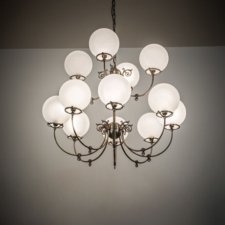 Revival 12-light chandelier glowing in interior space with warm ambient lighting.