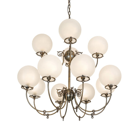 Lit view of gas and electric chandelier with frosted globe shades and antique brass finish.