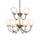 Side view of Revival 12-light chandelier with curved arms and globe glass shades.