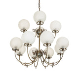 Unlit Revival gas and electric chandelier showing frosted globes and brass frame.