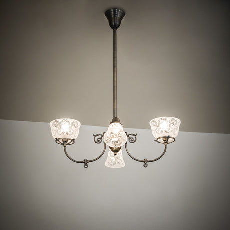 Revival gas and electric chandelier illuminating a room with warm ambient light.