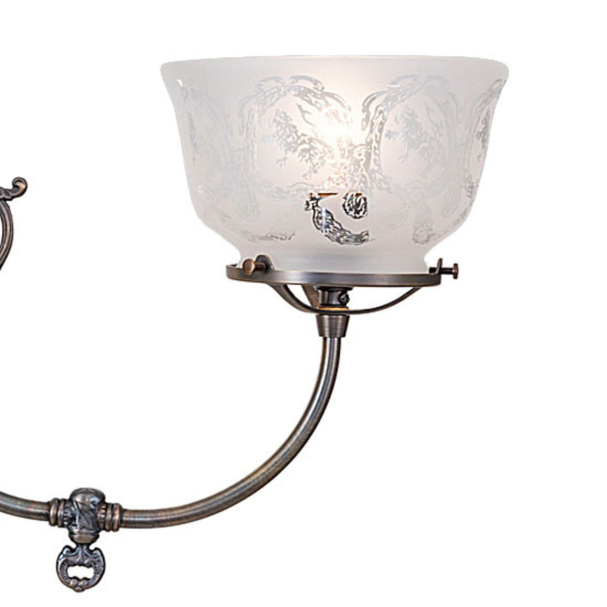 Close-up of etched glass shade and curved brass arm on revival gas and electric chandelier.
