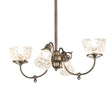 Lit view of 4 light chandelier with etched glass shades and antique brass finish.