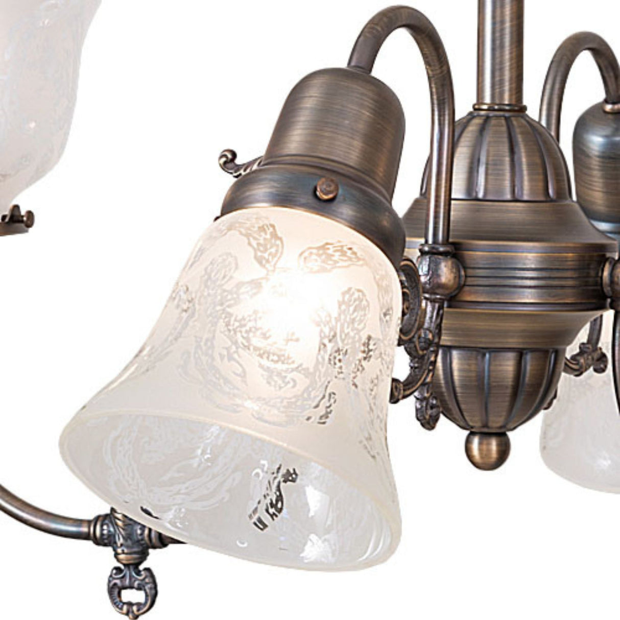Detail view of etched glass shade with wreath and garland motif on revival chandelier.