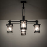 Roylance five light mission style chandelier illuminated with warm ambient lighting.